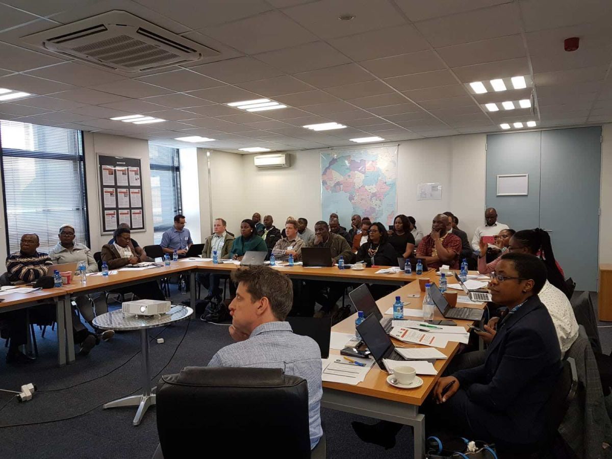 Project team members and stakeholders in large meeting room